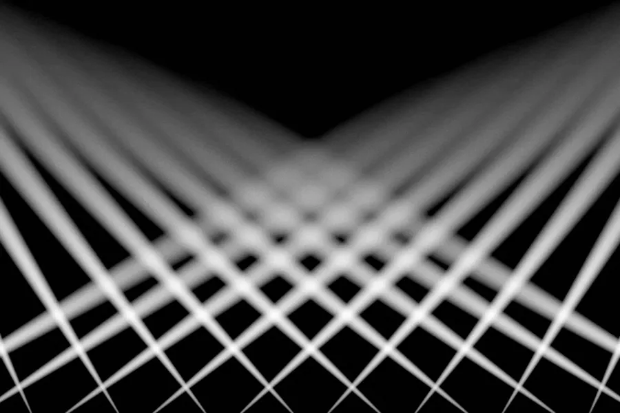 White beams of light crossing against a black background